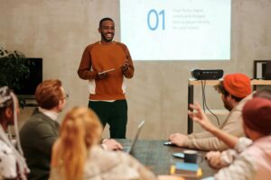 Presenter smiles while giving a workshop to a small marketing team